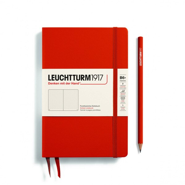 A red notebook with an elastic to keep it closed.